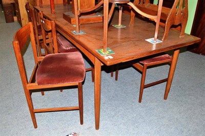 Lot 553 - A G-Plan draw leaf dining room table, sideboard and chairs