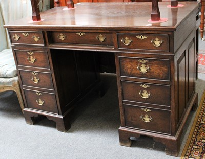 Lot 1218 - A Reproduction Oak Kneehole Desk, on bracket...