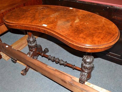 Lot 559 - A Victorian walnut kidney shaped side table with carved supports and turned stretcher