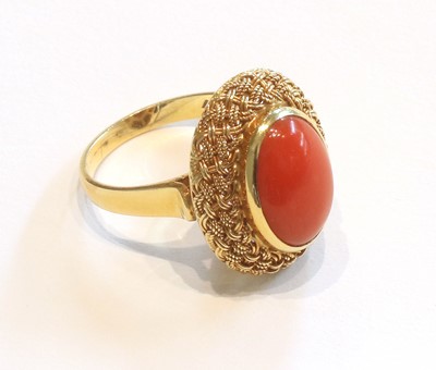 Lot 350 - An 18 Carat Gold Coral Ring, the oval cabochon...