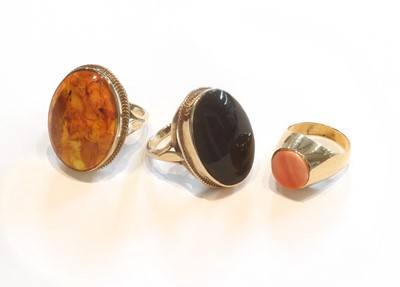 Lot 357 - A 9 Carat Gold Amber Ring, finger size N; A 9...