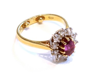 Lot 353 - An 18 Carat Gold Ruby and Diamond Cluster Ring,...