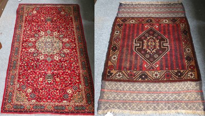 Lot 1088 - A Baluch Rug, the brick red field of stylised...