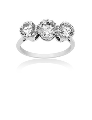 Lot 2307 - A Diamond Three Stone Ring the graduated round...