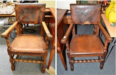 Lot 594 - A pair of oak bobbin-turned elbow chairs