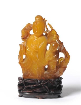 Lot 209 - A Chinese Amber Figure of Guanyin, late 18th/early 19th century, standing holding a fly whisk,...