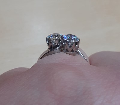 Lot 2331 - A Diamond Two Stone Twist Ring the round...