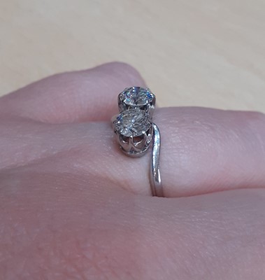 Lot 2331 - A Diamond Two Stone Twist Ring the round...