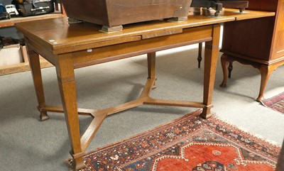 Lot 1149 - A Light Oak Extending Draw Leaf Dining Table,...