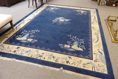 Lot 619 - Peking carpet, East China, the mid indigo field centred by a pagoda, the spandrels similar...