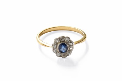 Lot 195 - A Sapphire and Diamond Cluster Ring, the oval...