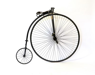 Lot 670 - A Penny Farthing Bicycle, the worn brown...