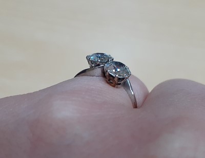 Lot 2329 - A Diamond Two Stone Twist Ring the round...