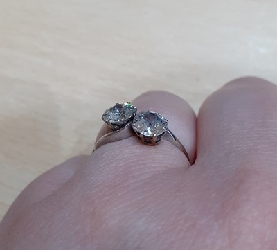 Lot 2329 - A Diamond Two Stone Twist Ring the round...