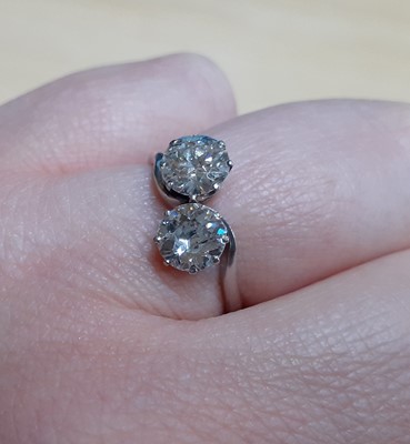 Lot 2329 - A Diamond Two Stone Twist Ring the round...