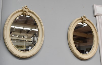 Lot 1356 - A Pair of Oval Painted Mirrors, surmounted by...