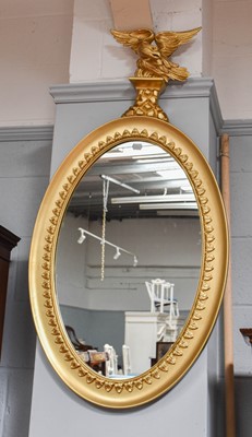 Lot 1127 - A Regency Style Gilt Oval Mirror, surmounted...