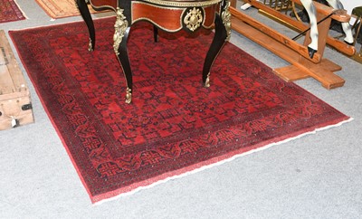 Lot 1203 - An Afghan Turkmen Rug, the crimson field with...