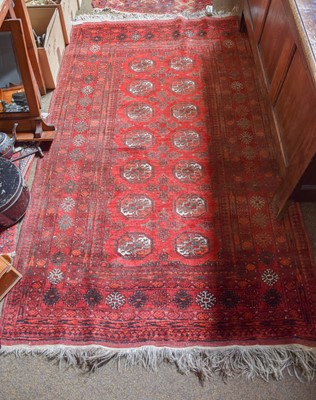 Lot 1004 - Afghan Rug, the crimson field of guls enclosed...