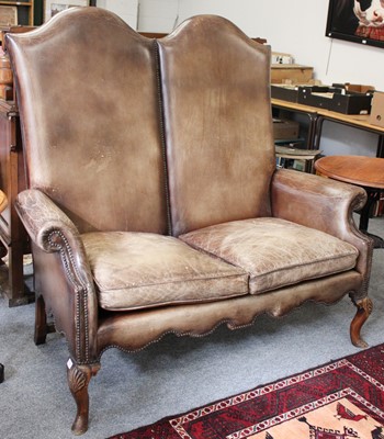 Lot 1203 - An Oak Framed Humpback Sofa, the high back and...