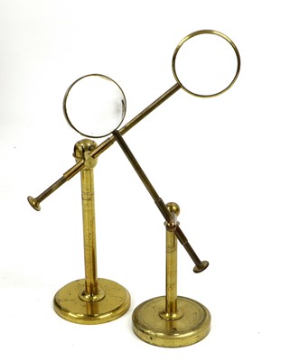 Sold at Auction: A SMALL BRASS MAGNIFYING GLASS on a stand.