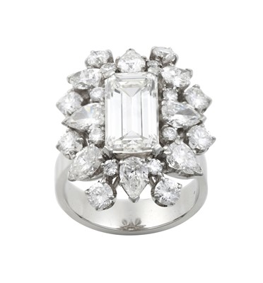 Lot 2337 - A Diamond Cluster Ring the emerald-cut diamond...