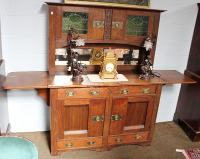 Lot 1249 - An Oak Arts and Crafts Dresser, with mirrored...