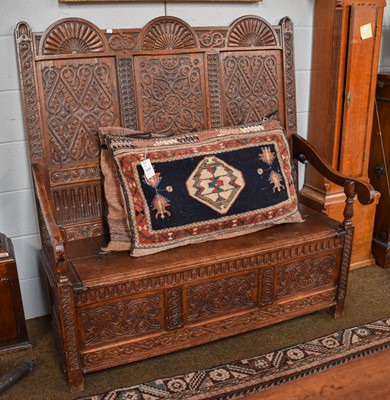 Lot 1385 - A Ornatley Carved Oak High Back Box Settle,...