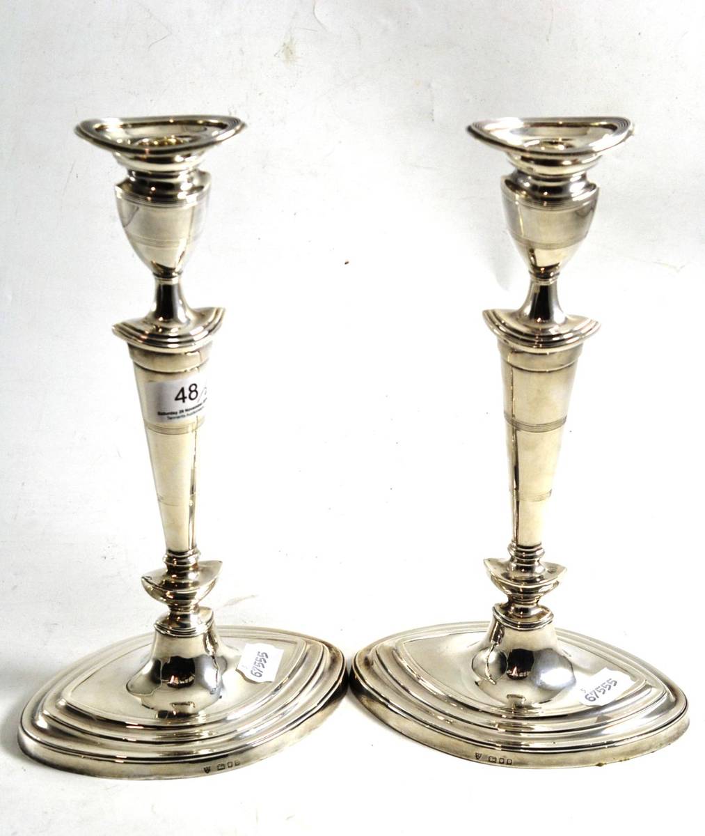 Lot 48 - A pair of silver loaded candlesticks, London 1930