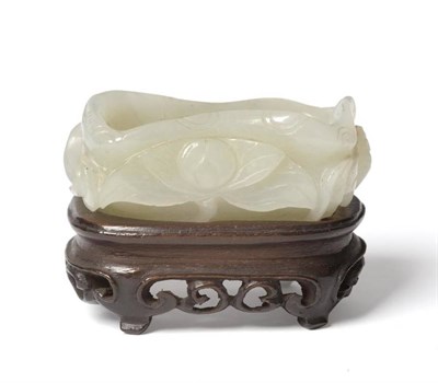 Lot 225 - A Chinese Jade Small Brush Washer, Qing Dynasty, in the form of a cupped lily pad, the exterior...