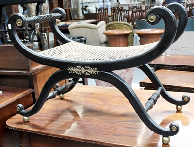 Lot 1252 - A Regency Canework Ebonised Stool, the scroll...