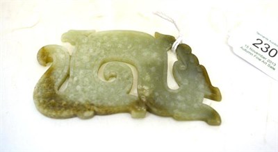 Lot 230 - A Chinese Celadon Jade Plaque, of archaic form, worked as a scrolling dragon with boss motifs, 10cm
