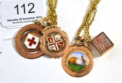 Lot 112 - Three 9ct gold fob pendants and one chain, and a 10 shilling note pendant and chain