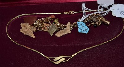 Lot 124 - A charm bracelet, most charms stamped ";14K"; (American motifs), and a 9ct gold necklace