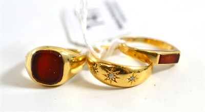 Lot 147 - An 18ct gold diamond three stone ring and two Cornelian set rings