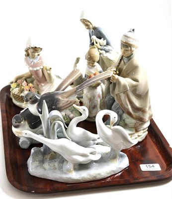 Lot 154 - Three Lladro figures of girls and another of a pair of swallows, and two Nao figures