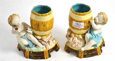 Lot 163 - Pair of Majolica pottery child and barrel ornamental vases