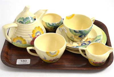 Lot 180 - A Clarice Cliff part tea set comprising teapot, milk jug, sugar bowl, teacup, two saucers and...