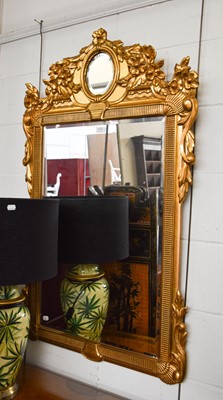 Lot 1113 - A Reproduction Gilt Framed Mirror, decorated...