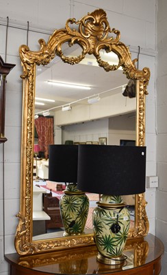 Lot 1107 - A Reproduction Gilt Framed Mirror, ornately...