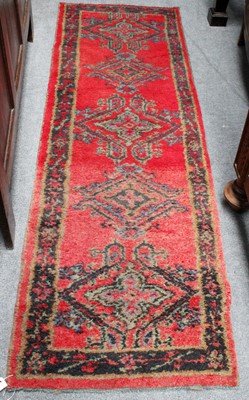 Lot 1218 - Ushak Runner, tomato red field with five...