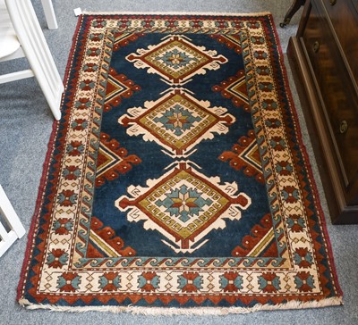 Lot 1211 - Kazak Design Rug The indigo field with three...