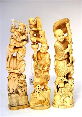 Lot 243 - A Japanese Marine Ivory Okimono, Meiji period, as a child holding a scroll standing on a man...