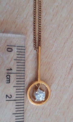 Lot 2090 - A Diamond Solitaire Pendant on Chain and A...