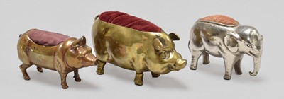 Lot 266 - Two Brass Pig Pin Cushions and a white metal...