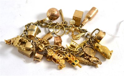 Lot 252 - A charm bracelet hung with charms