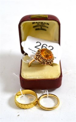 Lot 262 - An 18ct gold patterned band ring, a 9ct gold ring and a yellow paste ring