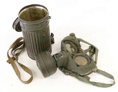 Lot 61 - A Second World War German Gas Mask, in green...