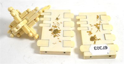 Lot 279 - Pair of early 20th century Japanese gilt decorated ivory whist markers and an ivory puzzle