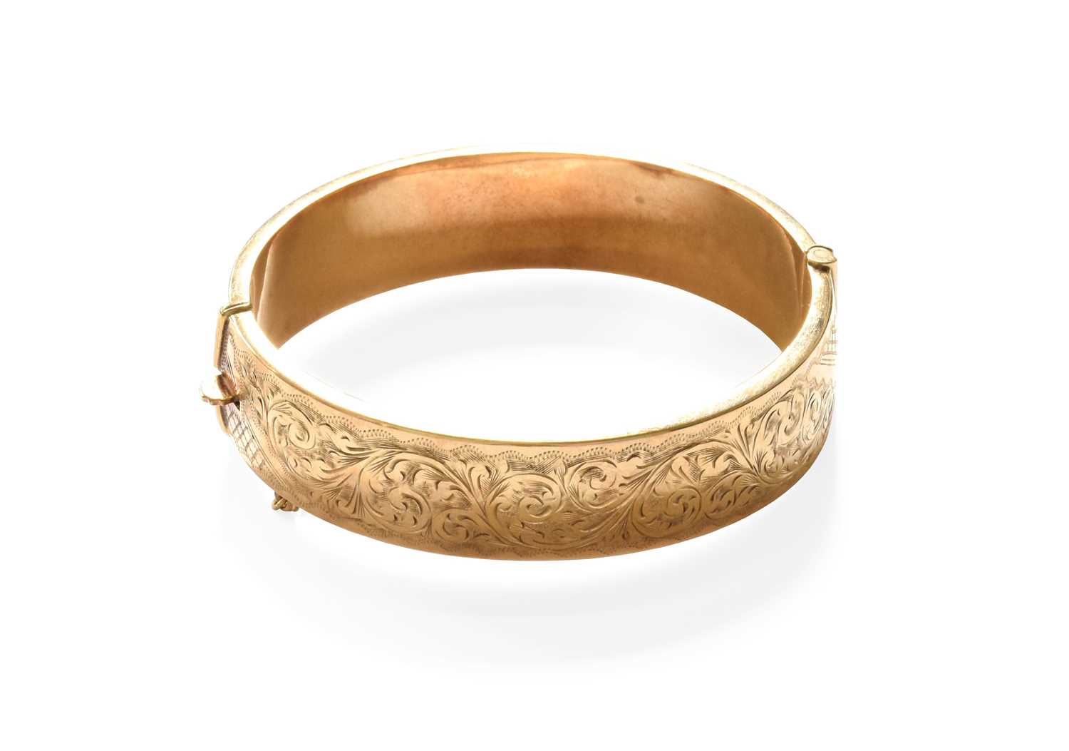 Lot 47 - A 9 Carat Gold Engraved Hinged Bangle, inner...